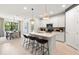 Bright kitchen with a center island and bar stool seating open to the dining room at 5703 Silverside Pine Ct, Lakewood Ranch, FL 34211
