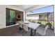 Inviting outdoor patio with dining table and chairs, offering a relaxing space with views of the backyard at 5703 Silverside Pine Ct, Lakewood Ranch, FL 34211