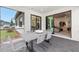 Outdoor patio featuring a dining table, chairs, and a screened enclosure for comfortable entertaining at 5703 Silverside Pine Ct, Lakewood Ranch, FL 34211