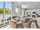 Bright dining area near kitchen has table setting, balcony access, and bar seating at the kitchen counter at 600 3Rd S Ave # 201, St Petersburg, FL 33701
