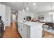 Open concept kitchen with white cabinets and an island that overlooks the living and dining areas at 600 3Rd S Ave # 201, St Petersburg, FL 33701