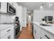 Contemporary kitchen with stainless steel appliances, white cabinets, and a marble backsplash at 600 3Rd S Ave # 201, St Petersburg, FL 33701