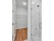 Modern shower area with glass doors, marble-like tile, and convenient shelving for toiletries at 600 3Rd S Ave # 201, St Petersburg, FL 33701
