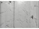 Luxurious marble shower featuring a modern showerhead, elegant fixtures, and pristine white tile at 600 3Rd S Ave # 201, St Petersburg, FL 33701