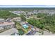 Wide aerial view of a residential community featuring mature trees, a pool, and well-maintained streets and landscaping at 600 Gardens Edge Dr # 614, Venice, FL 34285