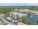 Aerial view of well-maintained condos with lush landscaping, surrounded by parking at 600 Gardens Edge Dr # 614, Venice, FL 34285