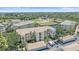 Aerial view of luxury condos surrounded by pond, palm trees, and convenient parking at 600 Gardens Edge Dr # 614, Venice, FL 34285