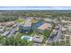 Aerial view of a community with ponds, mature trees, swimming pool, and well-maintained landscaping at 600 Gardens Edge Dr # 614, Venice, FL 34285