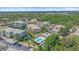Community aerial view featuring multiple condos, ponds, mature trees, a pool, and surrounding lush landscaping at 600 Gardens Edge Dr # 614, Venice, FL 34285
