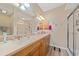This is a spacious bathroom featuring dual sinks with cabinets and a glass enclosed shower at 600 Gardens Edge Dr # 614, Venice, FL 34285
