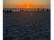 Beautiful beach with a sunset over the ocean and people enjoying the view at 600 Gardens Edge Dr # 614, Venice, FL 34285