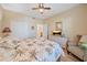 This bright bedroom has a palm tree theme, wall mounted tv, and an ensuite bathroom at 600 Gardens Edge Dr # 614, Venice, FL 34285