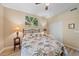 This is a bright bedroom with tropical themed decor, light colored walls and a closet at 600 Gardens Edge Dr # 614, Venice, FL 34285