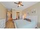 This is a bright bedroom with light colored walls, a ceiling fan, and ensuite bathroom and closet at 600 Gardens Edge Dr # 614, Venice, FL 34285
