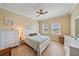 This is a bright bedroom with beach themed decorations, light colored walls, and a ceiling fan at 600 Gardens Edge Dr # 614, Venice, FL 34285