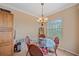 Bright dining area featuring a glass table, wicker chairs, and views to the outside at 600 Gardens Edge Dr # 614, Venice, FL 34285