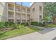 Attractive condo building featuring multiple stories with balconies, lush landscaping, and well-maintained grounds at 600 Gardens Edge Dr # 614, Venice, FL 34285