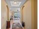 Inviting hallway with arched doorways and views of the screened porch at 600 Gardens Edge Dr # 614, Venice, FL 34285