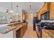 Open kitchen with breakfast bar and wood cabinets provides a great flow to the living area at 600 Gardens Edge Dr # 614, Venice, FL 34285