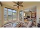 Spacious screened-in lanai offering views of the lake, living room, and dining area at 600 Gardens Edge Dr # 614, Venice, FL 34285