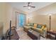 A cozy living room features a comfortable sectional couch and a window with views at 600 Gardens Edge Dr # 614, Venice, FL 34285