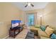 The inviting living room features a sectional sofa, tv, and a scenic view from the window at 600 Gardens Edge Dr # 614, Venice, FL 34285