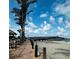 Picturesque view of the pier, beach, dining area, palm trees and the ocean on a clear day at 600 Gardens Edge Dr # 614, Venice, FL 34285