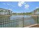 View of condo buildings surrounding peaceful pond with water fountain and lush landscaping at 600 Gardens Edge Dr # 614, Venice, FL 34285