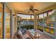 Relaxing screened porch with ceiling fan overlooking tranquil pond with fountain at 600 Gardens Edge Dr # 614, Venice, FL 34285