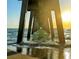 Ocean view from underneath a pier, featuring water and wooden support beams at 600 Gardens Edge Dr # 614, Venice, FL 34285