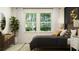 Cozy bedroom featuring a large window, modern furnishings, and a neutral color palette at 6838 E 115Th St, Palmetto, FL 34221