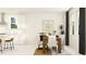 Bright dining room with white walls, wood table, and modern art, creating an inviting atmosphere at 6838 E 115Th St, Palmetto, FL 34221