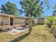 Spacious backyard featuring a shed, sunroom addition, and mature shade trees at 705 E Alabama St, Plant City, FL 33563