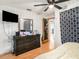 Bedroom featuring dark wood flooring, a dresser, and large mirror at 705 E Alabama St, Plant City, FL 33563