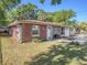 A well-maintained single story brick home with a tidy front yard and an attached garage at 705 E Alabama St, Plant City, FL 33563