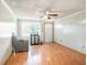 Bright living room with wood-look flooring, ceiling fan, and a front door view at 705 E Alabama St, Plant City, FL 33563