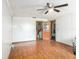 Spacious living room featuring wood-look floors, ceiling fan, and open doorway at 705 E Alabama St, Plant City, FL 33563