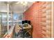 Enclosed sunroom featuring brick walls, a ceiling fan, and large windows at 705 E Alabama St, Plant City, FL 33563
