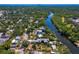 Expansive aerial perspective showcasing a waterfront home with a river view and lush surroundings at 7508 N Ola Ave, Tampa, FL 33604