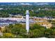 Unique shot of a tower in an area with commerce and roadways surrounded by mature trees at 7508 N Ola Ave, Tampa, FL 33604