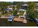 Waterfront home with private dock and boat lift surrounded by lush tropical foliage at 7508 N Ola Ave, Tampa, FL 33604