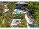 Stunning aerial view of a modern home with a backyard pool, fire pit, and lush landscaping at 7508 N Ola Ave, Tampa, FL 33604