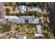 Panoramic aerial shot of a waterfront property with a pool, lush landscaping, and boat docks at 7508 N Ola Ave, Tampa, FL 33604