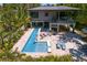 Stunning backyard oasis with a long pool, spa, travertine tile, sun loungers, and upper deck overlooking it all at 7508 N Ola Ave, Tampa, FL 33604
