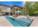 Stunning backyard with a sleek pool, spa, outdoor seating, and beautifully landscaped surroundings at 7508 N Ola Ave, Tampa, FL 33604