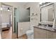 Bathroom featuring frosted glass enclosed shower, modern fixtures, and an adjacent bedroom at 7508 N Ola Ave, Tampa, FL 33604