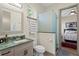 Bathroom featuring a modern sink and vanity with a glass enclosed shower, and an adjacent bedroom at 7508 N Ola Ave, Tampa, FL 33604