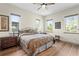 Bedroom with hardwood floors, and three windows that provide lots of natural light at 7508 N Ola Ave, Tampa, FL 33604
