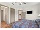 Bedroom featuring hardwood floors, and three door ways to other rooms in the house at 7508 N Ola Ave, Tampa, FL 33604