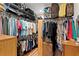 Spacious walk-in closet with ample storage, featuring rods, shelves, and a variety of hanging and folded clothes at 7508 N Ola Ave, Tampa, FL 33604